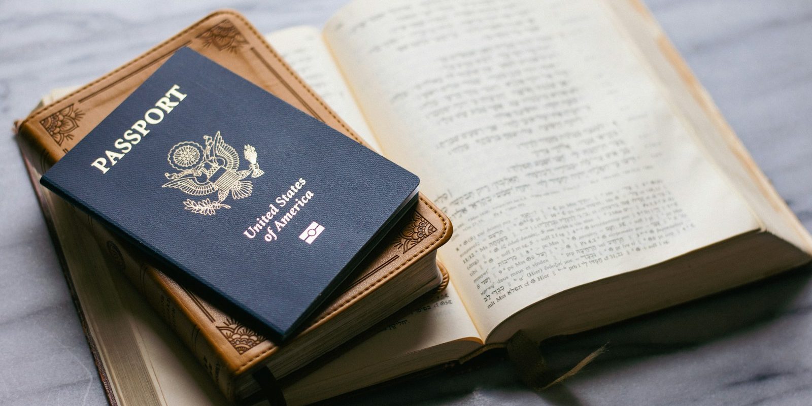 a passport sitting on top of an open book